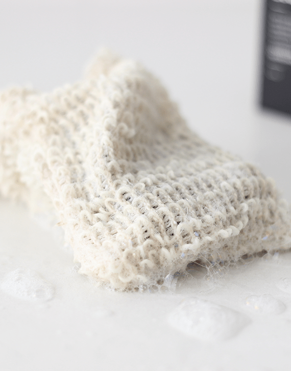 Brown and Coconut Wet Exfoliating Soap Bag wiith suds
