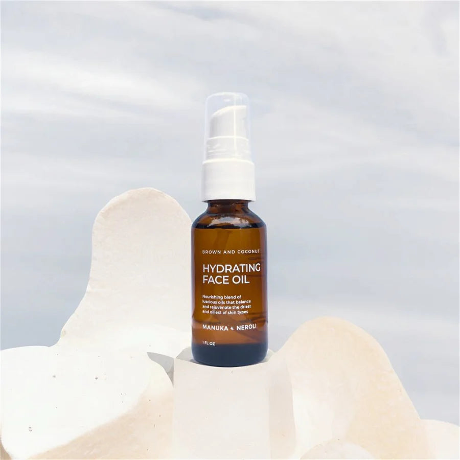 Brown and Coconut Hydrating Face Oil on a white rock